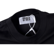 Close up of the authentic Sp5der branding neck label on the premium black The Spot Tee streetwear t-shirt.