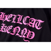 SP5DER Hellcat Kenny graphic streetwear tee with vibrant pink typography on a premium black cotton fabric base.