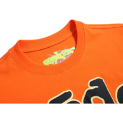 Close-up view of the inner neck label on the Sp5der Worldwide Star Beluga T-Shirt in an orange streetwear colorway.