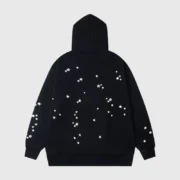 Back view of the Sp5der Jeffery Hoodie in black featuring white star graphic prints for a stylish streetwear look.