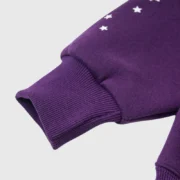 Close-up of the purple sleeve detail on the Sp5der Star OG Web V2 Hoodie featuring iconic white star graphic print.