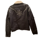 Sp5der trucker jacket featuring a sherpa lining and a bold rhinestone spider web graphic design on the back.