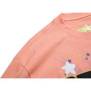 Close-up of a peach Sp5der graphic t-shirt featuring a unique artistic design with stars and a number five motif.