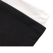 Close-up view of the premium fabric texture on the black and white SP5DER Pro LW performance streetwear t-shirt.