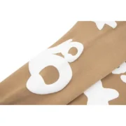 Light brown Sp5der Beluga hoodie sleeve featuring white graphic print detail for a trendy and stylish urban look.