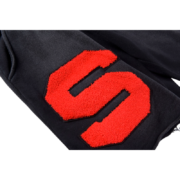 Close-up of the Sp5der Cut Sweatshort in black featuring a bold, textured red logo detail on the premium fabric.