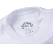 The interior neck branding label of the white Sp5der Juan V2 Tee, highlighting the Sp5der worldwide logo design.