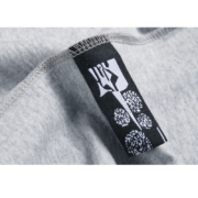 Close-up view of the inner neck branding label on the authentic Sp5der Arach Phobia New York streetwear t-shirt.