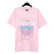 Pink Sp5der Young Thug Atlanta graphic T-shirt featuring a spider web print and blue stars, front view, hanging.