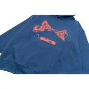 Front view of the premium navy blue Sp5der cropped hoodie featuring an orange distressed graphic print design.