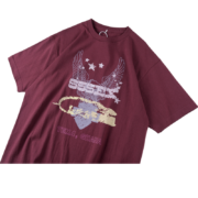 Maroon SP5DER Worldwide 5EX tee shirt featuring a graphic print of wings, stars, and Tema, Ghana branding.