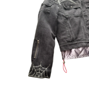 Black Sp5der Worldwide denim jacket featuring signature rhinestone spider web detailing on the sleeve and front pocket