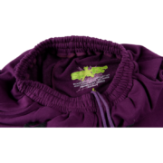 Close-up view of the interior label detail inside the purple Sp5der OG Web Logo sweat shorts featuring brand branding.