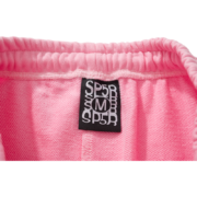 Close-up view of the interior pink fabric and size M branding tag on the Sp5der Atlanta Sweatpants for streetwear.