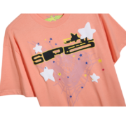 Peach Sp5der print t-shirt featuring a bold graphic design with stars and spiderweb motifs in a casual streetwear style.