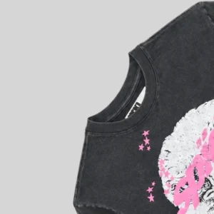 Close-up view of the Sp5der Screaming Eagle Tee showcasing the black fabric and pink graphic print details.