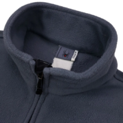 Close-up view of the Sp5der fleece jacket featuring the inner neck label with brand logo and zipper detailing.