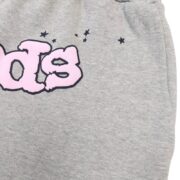 Close-up view of the premium grey French Terry cotton fabric on a Sp5der OG Web Logo sweat short with pink branding.