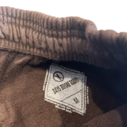 Close-up view of the interior tag on the Sp5der x Cactus Jack Rodeo shorts featuring the Days Before Rodeo branding.