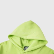 Close-up of the bright green hood on a premium Sp5der OG Web V2 streetwear pullover hoodie for men and women.