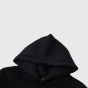 Close-up view of the hood detail on the black Sp5der x Metro Boomin Heroes & Villains collaboration streetwear hoodie.