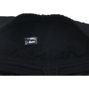 Close-up view of the elasticated waistband and internal brand tag on the SP5DER Black OG Web Sweatpants design.