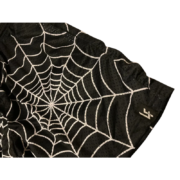 Close-up detail of the black mesh Lost Files Sp5der Web Short featuring an iconic white spider web graphic design.