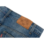Sp5der 5Star Vintage 501 Denim jeans showing the back view with a detailed brown leather patch and signature branding.