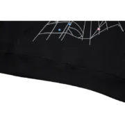 The Sp5der P*NK Hoodie in Black features a detailed hem design with iconic web graphics and star print detailing.