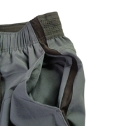 Close-up view of the elastic waistband and technical fabric detailing on the grey Sp5der Active TECH performance shorts.