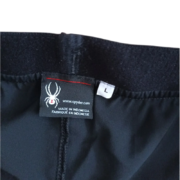 Detailed view of the Sp5der unisex Vista running shorts interior label, featuring brand logo and size L indicator.
