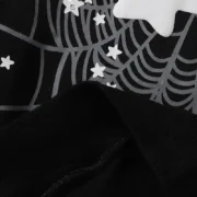 Close-up view of the Sp5der Jeffery Hoodie in black featuring high-quality fabric, a spiderweb print, and white stars.