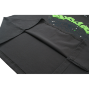 Close-up view of the premium hem detail on the charcoal Sp5der Wait Web T-shirt with signature green logo branding.