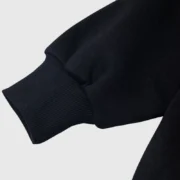 Close-up view of the ribbed cuff detail on the premium heavyweight black Sp5der Phantom Web hoodie streetwear.