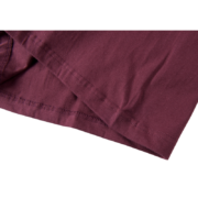 Close-up view of the high-quality fabric texture on a maroon SP5DER Worldwide 5EX Tee Shirt showing hem stitching detail.