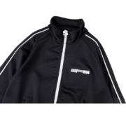 A sleek black Sp5der G550 high-performance jacket featuring white piping details and a modern athletic design.