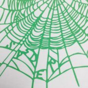 Close-up of the iconic green spider web graphic on the crisp white Sp5der OG Web T-shirt for a streetwear look.