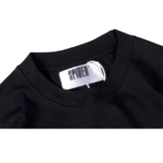 Close-up view of the white neck label on a black SP5DER Hellcat Kenny streetwear tee showing brand branding details.