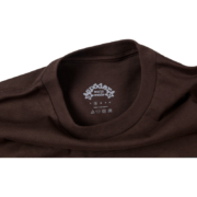 Close-up view of the inner neck label on the premium brown Sp5der 555 streetwear t-shirt with signature branding.