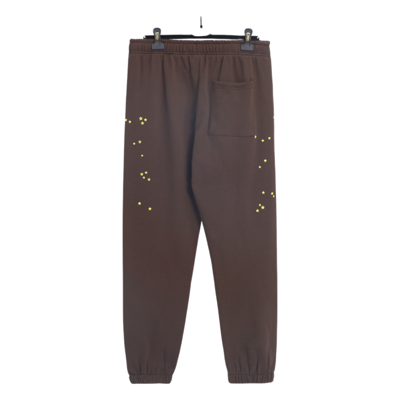 Back view of brown Sp5der 555 555 sweatpants with yellow star accents, featuring a relaxed fit and premium fabric.