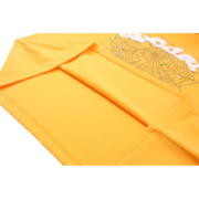 Close-up view of the yellow Sp5der Wait Web T-shirt showing detailed hem stitching and iconic web graphic print.