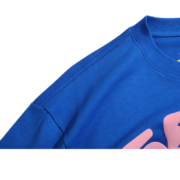 Close-up of the blue Sp5der Worldwide Star T-Shirt showing premium fabric, reinforced shoulder stitching, and collar.