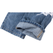 Close-up view of the hem detail on the blue Sp5der Vintage Web Jean Denim featuring distressed style and iconic print.