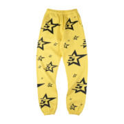 Front view of the vibrant yellow Sp5der 5Star sweatpants featuring a black star logo pattern throughout the design.