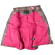 The interior view of a SP5DER Real Tree Puffer Vest showing its bright pink lining and camo outer shell design.