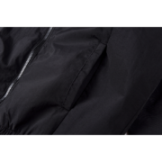 Close-up view of the black Sp5der Pro windbreaker jacket fabric, showcasing the high-quality zipper and pocket detail.