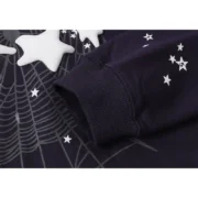 Close-up of the Sp5der Atlanta Hoodie in navy blue showing sleeve detail, star graphics, and intricate spiderweb print.