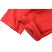 Close up view of the Sp5der Red Atlanta Open Leg Sweatpants showing the high-quality fabric and hem detail design.