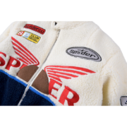 Close-up view of the Sp5der Wor1dwide 555555 Hunters Sherpa Jacket featuring bold branding and graphic chest patches.