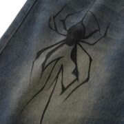 Durable denim shorts from Sp5der featuring a bold and unique black spider graphic print in a casual streetwear style.